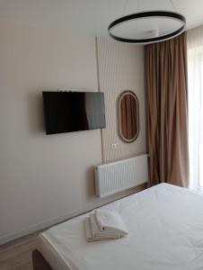 a bedroom with a bed and a flat screen tv at Люкс залізничний вокзал in Luts'k