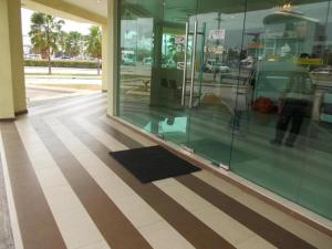 a glass storefront with a black mat on the floor at OYO 90442 Newtown Star Hotel in Klang
