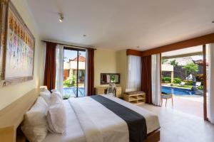 Postel nebo postele na pokoji v ubytování Casa Dewa Suite Villa Ubud