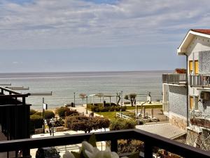 a view of the ocean from the balcony of a building at Holidaycasa Robert - Eleganza e comfort sul mare in Sperlonga +15 photos