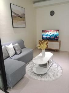 a living room with a couch and a coffee table at Matina Enclaves 1 bedroom in Davao City