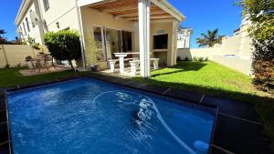 a swimming pool in the yard of a house at Villa on Private Estate with Pool in Hermanus