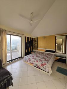 a bedroom with a large bed and a large window at Blue Haven Villa - Luxurious 3BHK Stay in Jodhpur