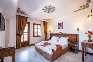 a hotel room with a bed and a desk at Costa Bitezhan Hotel - All Inclusive in Bitez