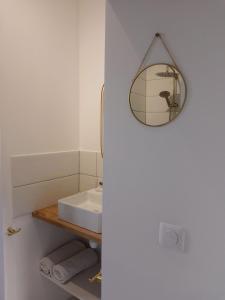 a bathroom with a sink and a mirror on the wall at Le Clos doré Baie de Somme in Abbeville +6 photos
