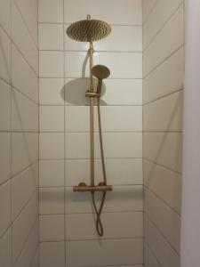 a bathroom with a shower with white tiles at Le Clos doré Baie de Somme in Abbeville
