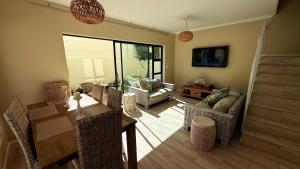 a living room with a couch and a table at Villa on Private Estate with Pool in Hermanus