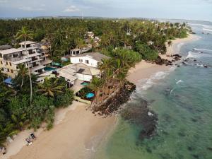 an aerial view of a beach with houses and the ocean at Shell House in Matara