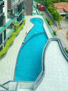 an overhead view of a swimming pool in a building at 1BR Luxury The City Phuket in Ban Ket Ho