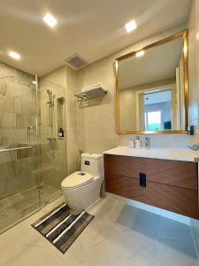 a bathroom with a toilet and a sink and a shower at 1BR Luxury The City Phuket in Ban Ket Ho