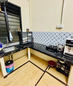 a kitchen with a counter top and a sink at Wawa Homestay Bandar Jeli - 2 in Jeli +6 photos