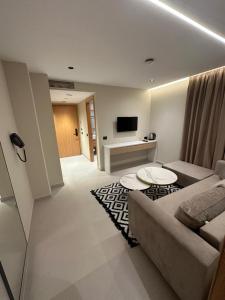 a living room with a couch and a table at Calma Boutique Hotel in Vlorë