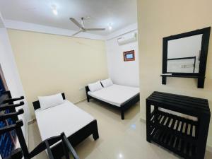 Voodi või voodid majutusasutuse Natraj Guest House toas