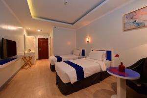 Ένα ή περισσότερα κρεβάτια σε δωμάτιο στο T Shine Resort and Spa