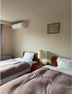 Postel nebo postele na pokoji v ubytování Asama Kogen Hotel
