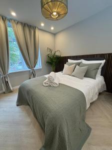 a bedroom with a large bed with a towel on it at The Stylish Gem of Den Haag Aprt R1 in The Hague