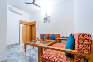a living room with a couch and a table at Hotel Chandrawati Palace in Ābu Road