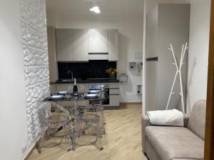 a kitchen and living room with a table and a couch at Dimora Eleonora in San Donato Milanese +43 photos
