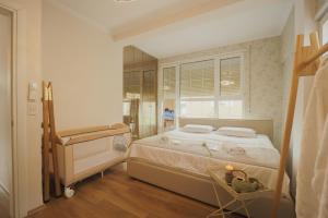 a bedroom with a large bed and a mirror at Ingrit Gjoni Villas in Draç