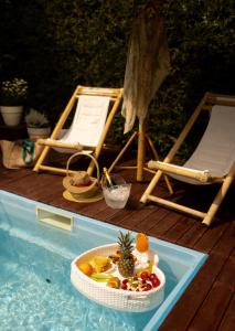 a tray of fruit in a bowl in a swimming pool at Ingrit Gjoni Villas in Draç +43 photos