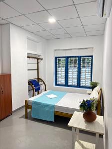 a hospital room with a bed and a window at Liyaa Blue Beach Weligama in Weligama