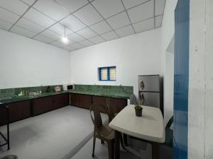 a kitchen with a table and chairs in a room at Liyaa Blue Beach Weligama in Weligama
