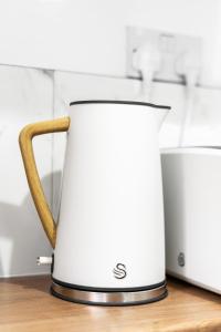 a coffee maker sitting on top of a counter at Stylish Birmingham Apartment For Groups, Family & Work in Birmingham