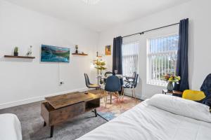 a bedroom with a bed and a desk and a table at Stylish Birmingham Apartment For Groups, Family & Work in Birmingham