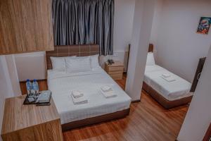 Postel nebo postele na pokoji v ubytování Palz Empire Hotel Temerloh