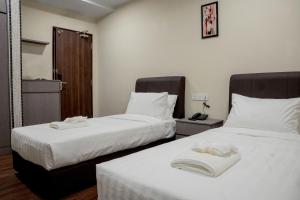 Postel nebo postele na pokoji v ubytování Palz Empire Hotel Temerloh