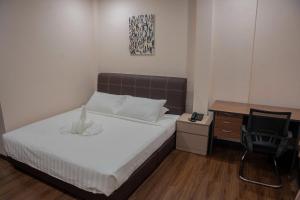 Postel nebo postele na pokoji v ubytování Palz Empire Hotel Temerloh