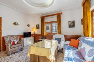 a living room with a couch and a table at Casa Solariega con encanto in Padul