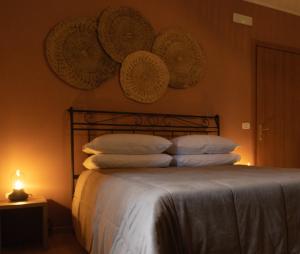 a bedroom with a bed with hats on the wall at Tarantini Casa Vacanze in Viggianello