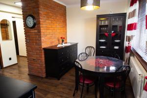 a dining room with a table and a brick wall at Apartament BonTon in Ostrowiec Świętokrzyski