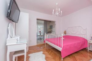 Posteľ alebo postele v izbe v ubytovaní Apartmani Antunović Podgora