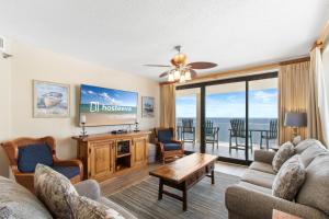 a living room with a couch and a table at Windward Pointe Condominiums in Orange Beach