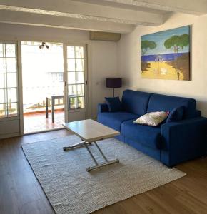 un salon avec un canapé bleu et une table basse dans l'établissement Emeraude, à Saint-Raphaël