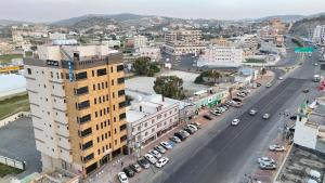 an aerial view of a city with cars parked on a street at Qimam Park Alnamas 6 in Al Namas