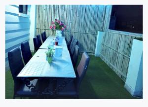 a long long table with chairs and flowers on it at Hotel Times in Kathmandu