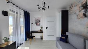 a living room with a couch and a table at City Break Apartment z gabinetem, 2 łazienkami, tarasem i garażem podziemnym w cenie in Rzeszów