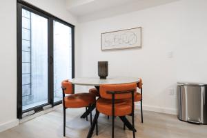 a dining room with a table and four chairs at Unit 1 Stylish Studio with King Bed and Sofa Bed in Washington +19 photos