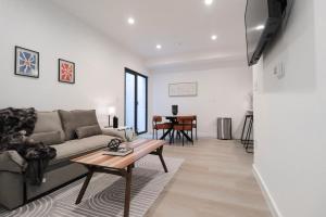 a living room with a couch and a table at Unit 1 Stylish Studio with King Bed and Sofa Bed in Washington