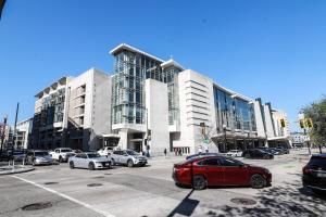 a red car parked in front of a large building at Unit 1 Stylish Studio with King Bed and Sofa Bed in Washington