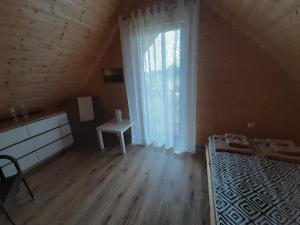 Posteľ alebo postele v izbe v ubytovaní Czarcie Chatki