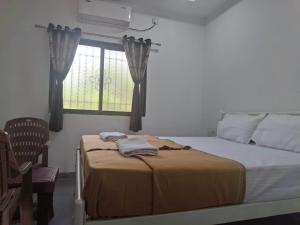 Postel nebo postele na pokoji v ubytování Jayshree Cottages