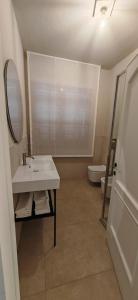 a bathroom with a sink and a mirror and a toilet at Padre Relais di Campagna in Collemezzano +27 photos