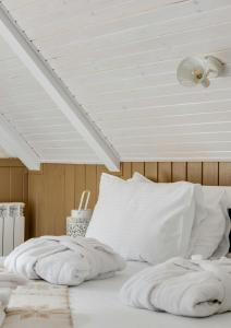 a bed with white sheets and a white ceiling at Welcome stay AC ROOM in Ayodhya