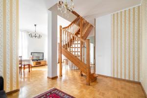 a living room with a staircase and a dining room at Large and cozy 2-level apartment in Tallinn