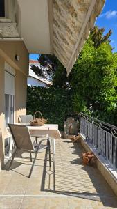 a table and a chair on a patio at Lucky Apartment in Nea Kalikratia