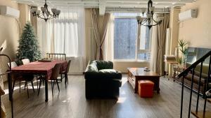 a living room with a table and a christmas tree at Beijing City center - Two bedroom family flat with Queen-size beds in Beijing